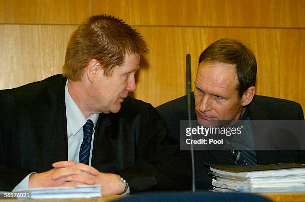 Armin Meiwes talsk to his lawyer Harald Ermel as they attend his retrial on January 12, 2006 at the District Court in Frankfurt, Germany. Meiwes was...