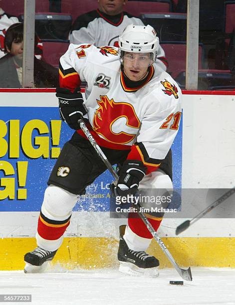 Andrew Ference of the Calgary Flames controls the puck during the game against the New Jersey Devils on December 7, 2005 at Continental Airlines...
