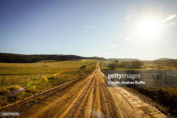 general view of a mountain road with sun - andres ruffo stock-fotos und bilder