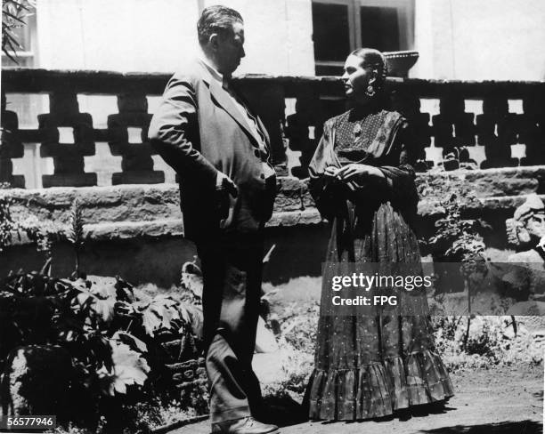 Married Mexican painters Diego Rivera and Frida Kahlo talk together in the garden, near the porch of Kahlo's home, Mexico City, Mexico, 1937.