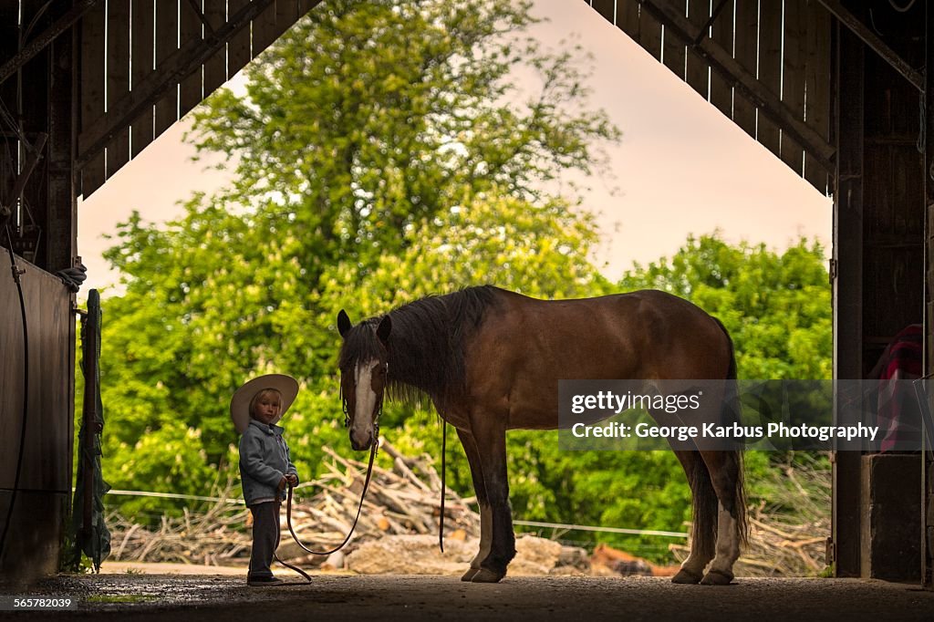 Boy standing with horse