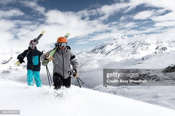 men carrying skis in snow, zermatt, valais, switzerland - friends skiing stock pictures, royalty-free photos & images