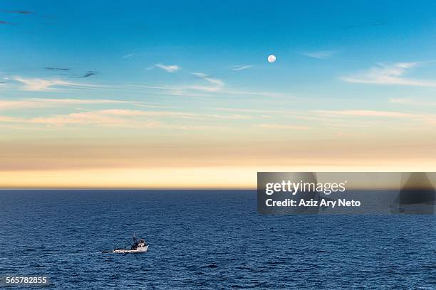 fishing boat and full moon at dusk, ponta do criminoso, buzios, rio de janeiro, brazil - criminoso stock pictures, royalty-free photos & images