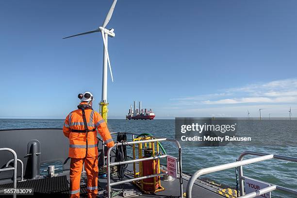 crew member on deck of boat on offshore wind farm - crew stock pictures, royalty-free photos & images