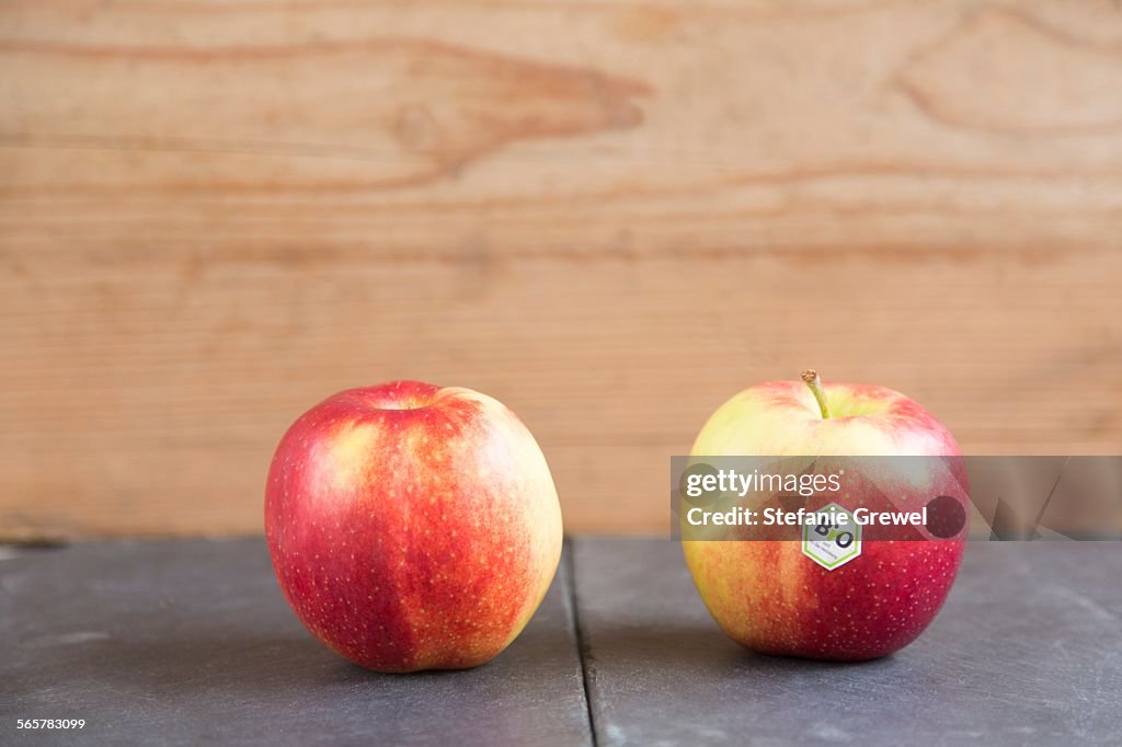 Still life of two apples - one with bio label