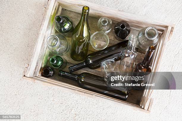 wooden crate containing variety of empty bottles for recycling - glass box stock pictures, royalty-free photos & images