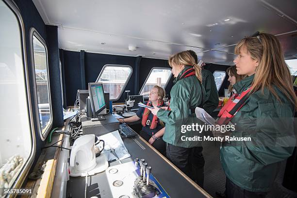 marine biologists in laboratory on research ship - wildlife research stock pictures, royalty-free photos & images