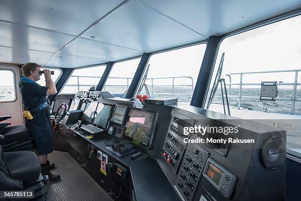 captain at the bridge of marine research ship - skipper stockfoto's en -beelden