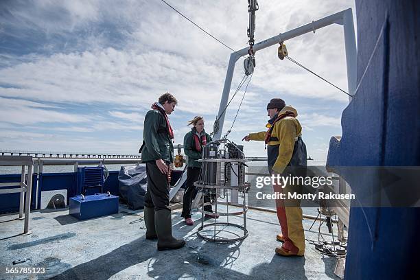 scientists assembling sea water sampling experiment on research ship - wildlife research stock pictures, royalty-free photos & images