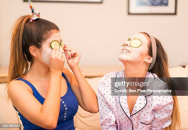 two young women wearing face masks - night in fotografías e imágenes de stock