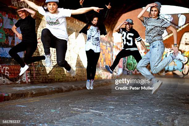 young women jumping in mid air - hip hop dance fotografías e imágenes de stock