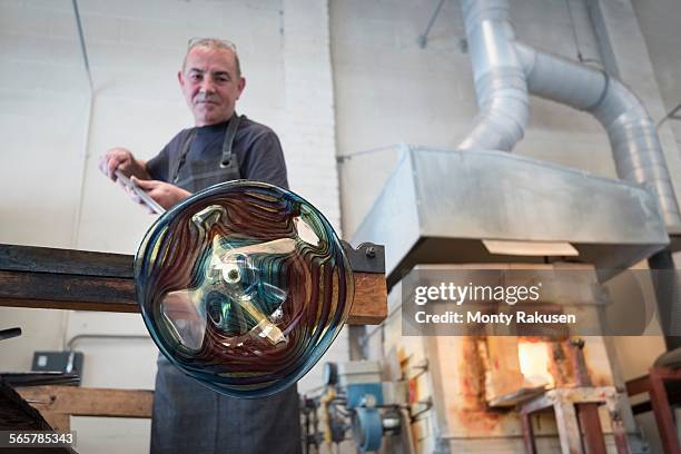 glassblower spinning hot glass - glass blowing stock pictures, royalty-free photos & images