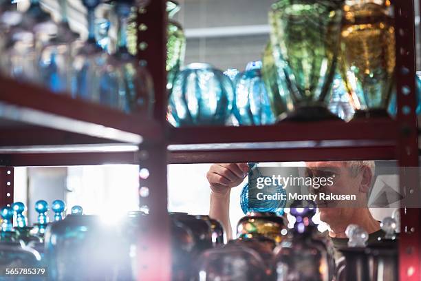 glassblower inspecting finished glassware - glass blowing stock pictures, royalty-free photos & images
