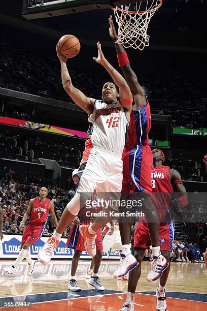 Antonio McDyess of the Detroit Pistons tries to block a shot by Sean May of the Charlotte Bobcats during the game on December 17, 2005 at the...