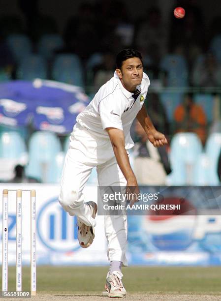Indian off spinner Anil Kumble delivers the ball to Pakistani batsman Shoaib Malik during the first day of the first cricket Test match between...