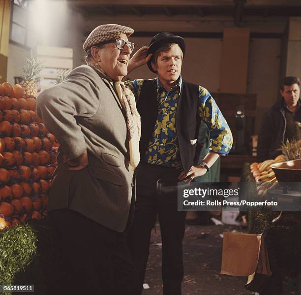 English actors and singers, Stanley Holloway on left and Peter Noone, lead singer with the pop group Herman's Hermits, on right, pictured together on...