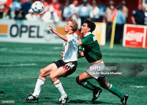 Juergen Klinsmann of Germany and Gustavo Quinteros of Bolivia in action during the World Cup match between Germany and Bolivia on June 17, 1994 in...
