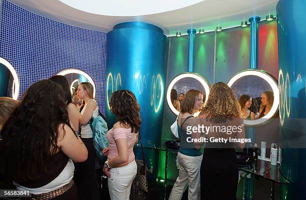 Patrons are shown in the uni-sex rest room of the Seamless Adult Ultra Lounge during the club's grand opening early December 18, 2005 in Las Vegas,...