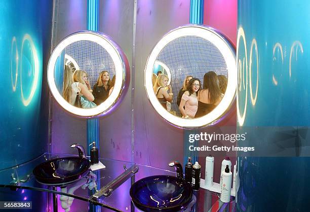 Patrons are shown in the uni-sex rest room of the Seamless Adult Ultra Lounge during the club's grand opening early December 18, 2005 in Las Vegas,...