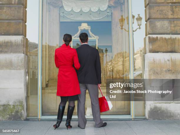 caucasian couple window shopping on city sidewalk - french budget stock pictures, royalty-free photos & images