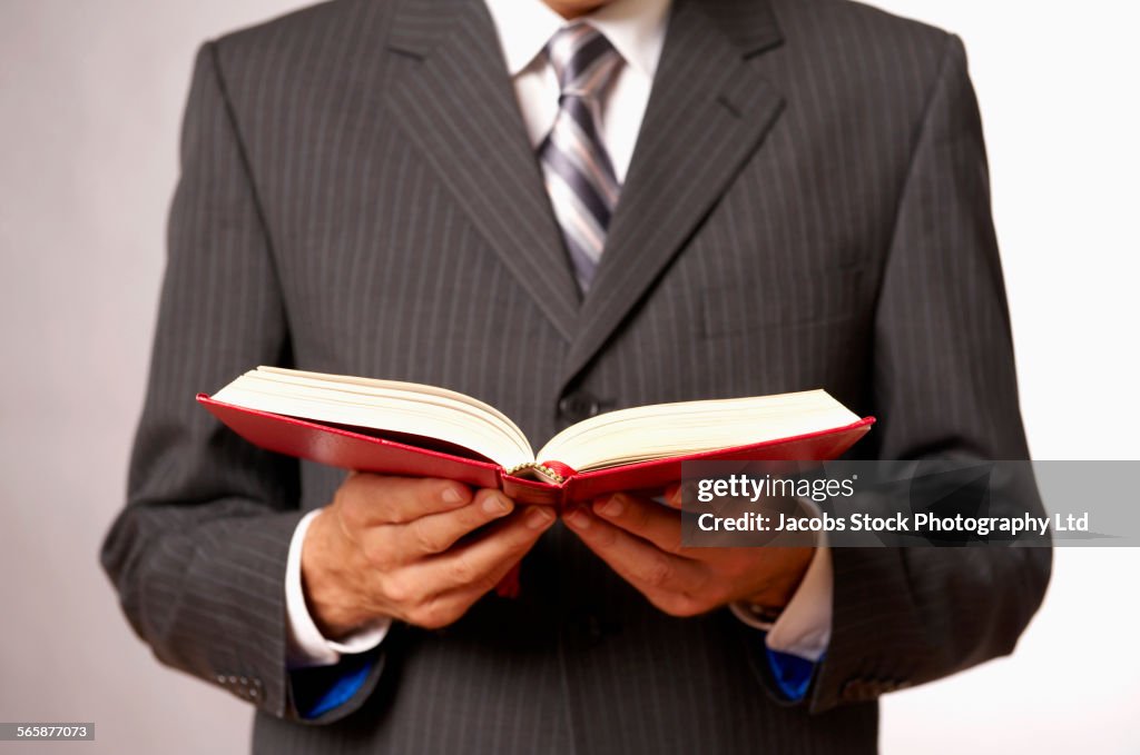 Caucasian businessman reading book