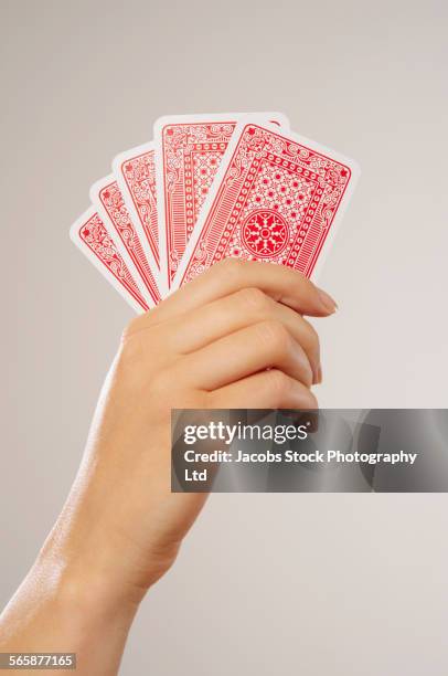 caucasian woman holding playing cards - carta de baralho imagens e fotografias de stock