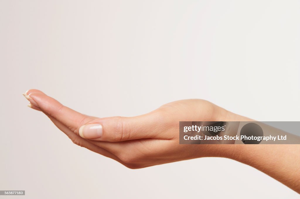 Close up of cupped hand of Caucasian woman