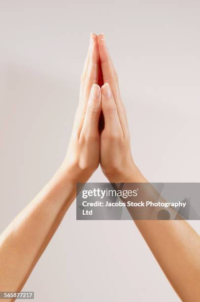 close up of clasped hands of caucasian woman - hands crossed stock-fotos und bilder