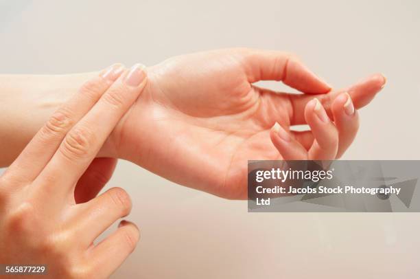 caucasian woman checking her pulse - taking pulse bildbanksfoton och bilder