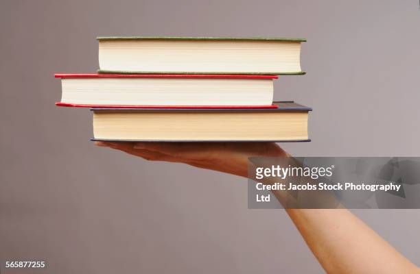 caucasian woman holding stack of books - textbook fotografías e imágenes de stock