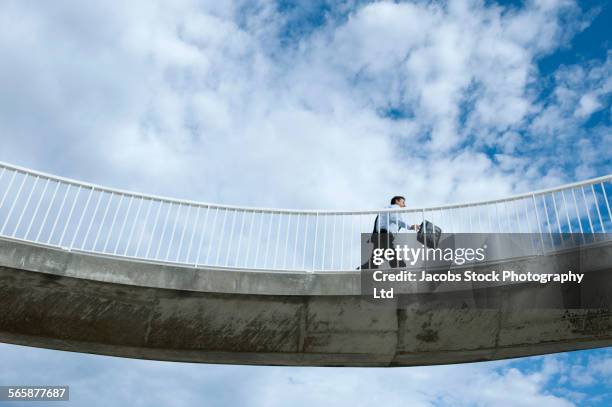 caucasian businessman walking on elevated walkway - footbridge stock pictures, royalty-free photos & images