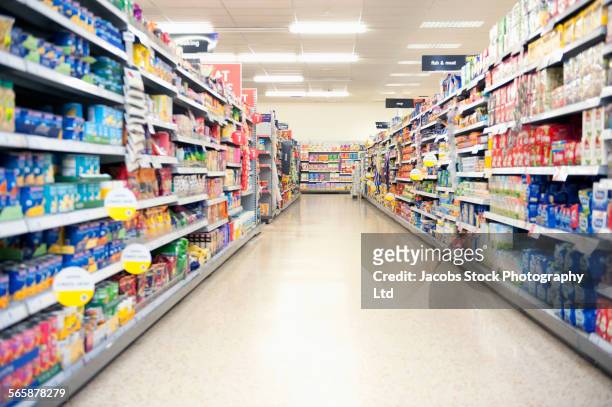 shelves in grocery store aisle - groceries stock-fotos und bilder
