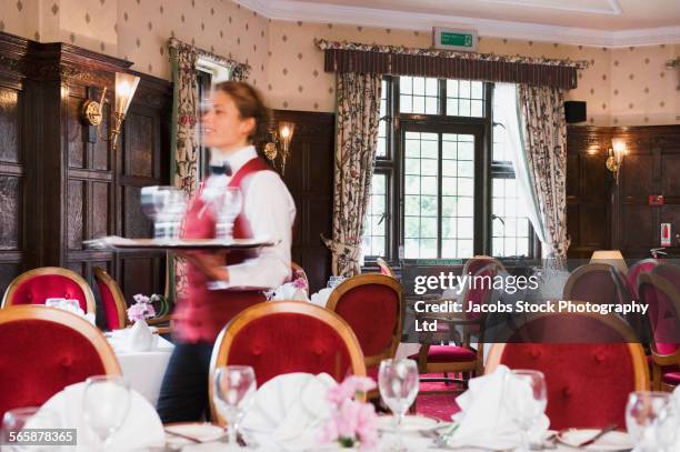 blurred view of caucasian waitress walking in empty restaurant - woodhall spa stock pictures, royalty-free photos & images