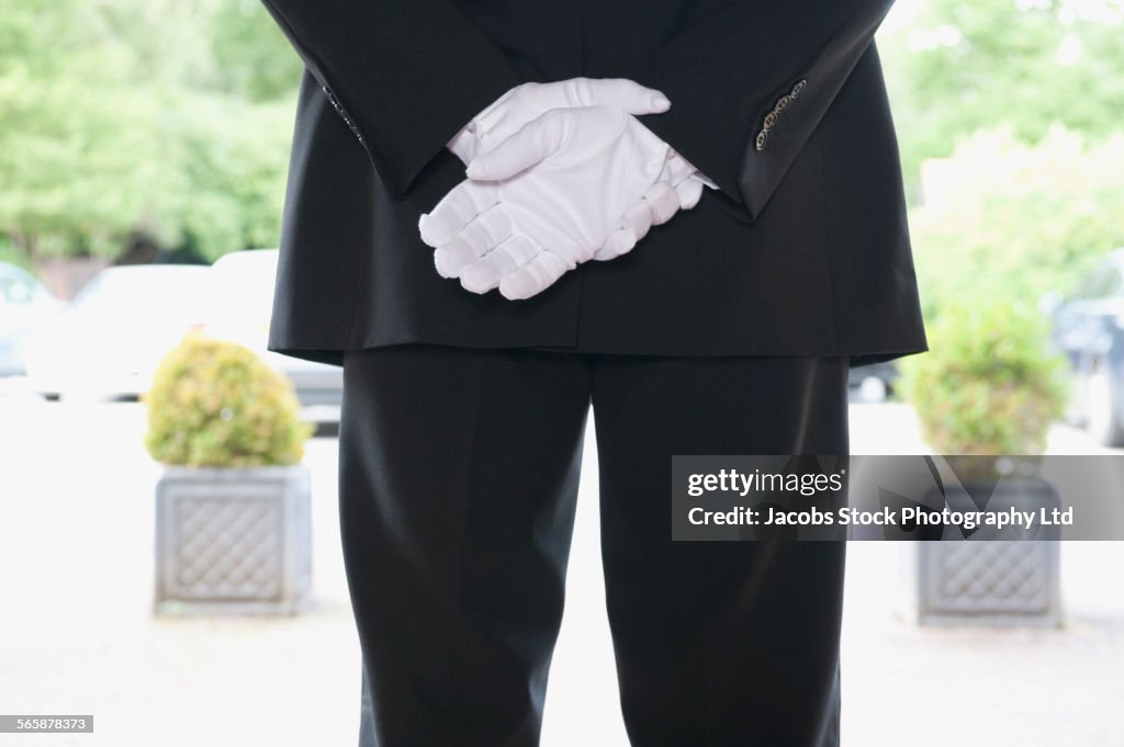 Close up of Caucasian butler waiting at hotel entrance