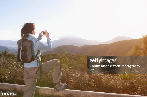 hispanic hiker photographing remote landscape - launceston australia stock pictures, royalty-free photos & images