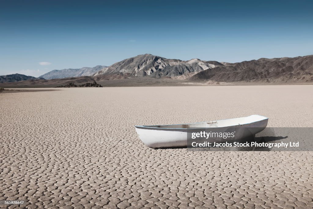 Empty boat in dry desert field