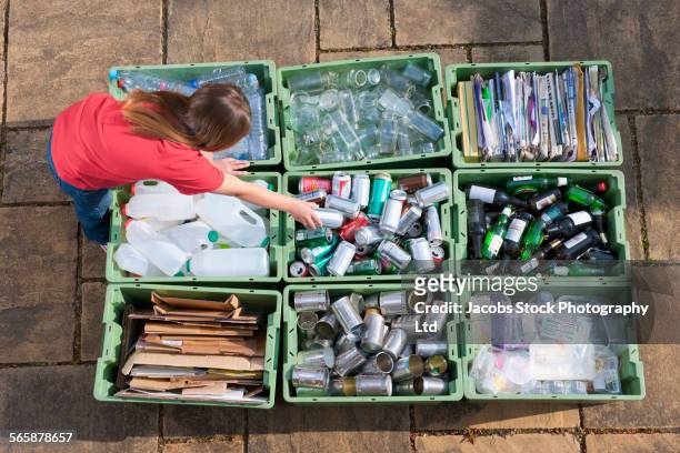caucasian teenage girl organizing recycling bins - bottle bank stock pictures, royalty-free photos & images