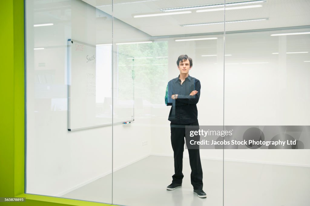 Caucasian businessman standing near whiteboard in office