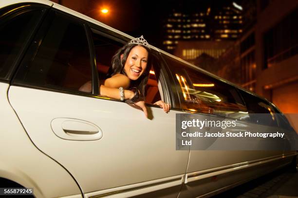 hispanic woman leaning out limousine window at night - limo night stock pictures, royalty-free photos & images