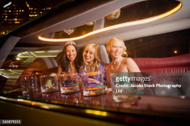 smiling women celebrating in limousine - limo night stock pictures, royalty-free photos & images