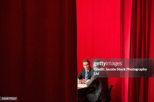 caucasian businessmen talking near red curtain - victoria secret stock-fotos und bilder