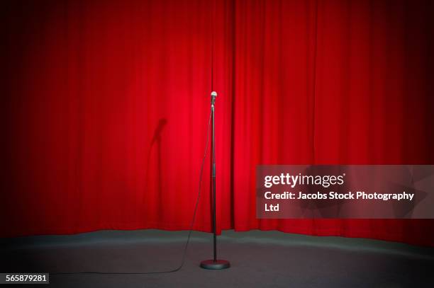 empty microphone in spotlight on stage - microphone stand stock pictures, royalty-free photos & images