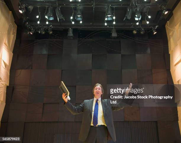 caucasian businessman talking on stage - preacher stock pictures, royalty-free photos & images