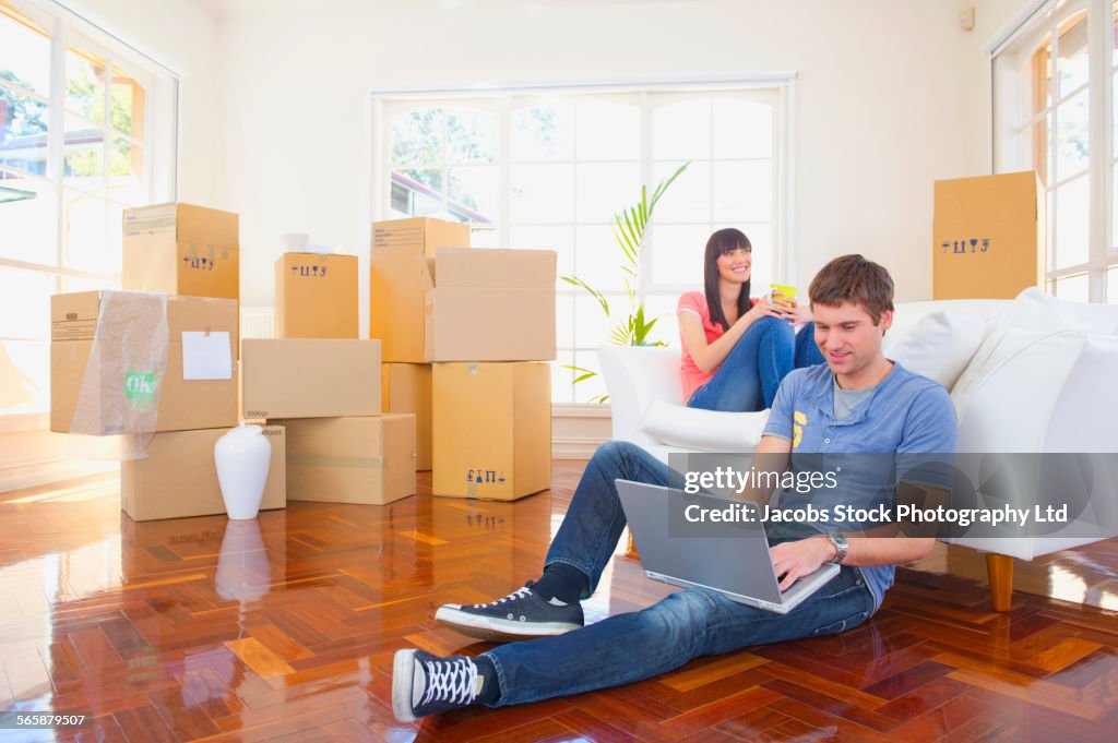 Couple relaxing on floor of new home