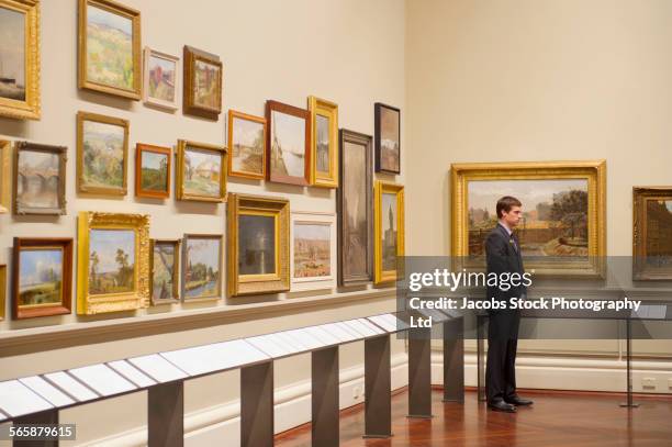 caucasian security guard standing in art museum - melbourne art stock pictures, royalty-free photos & images