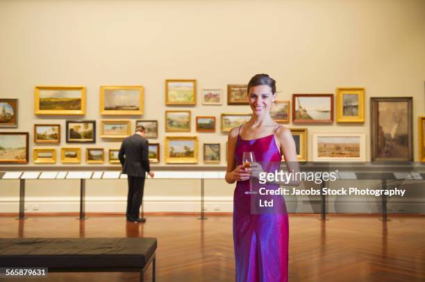 caucasian woman in evening gown smiling in art museum - melbourne art stock pictures, royalty-free photos & images