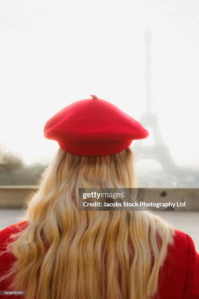 Caucasian woman admiring Eiffel Tower, Paris, Ile-de-France, France