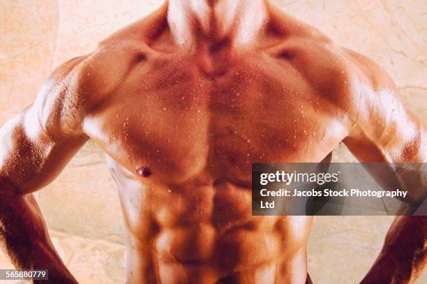 caucasian athlete flexing sweaty abdominal muscles - male chest stock pictures, royalty-free photos & images