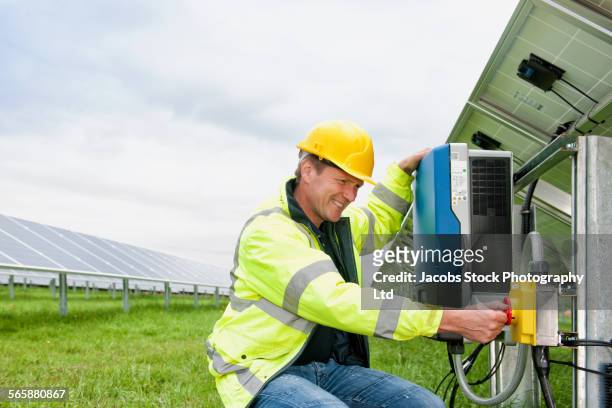 caucasian technician using industrial control panel - fornecimento de energia - fotografias e filmes do acervo