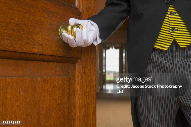 close up of caucasian butler opening door - victor butler stock pictures, royalty-free photos & images